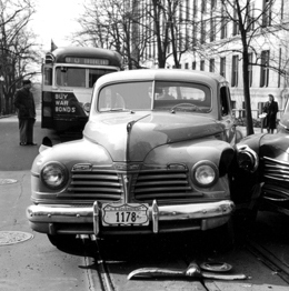 A "large federal shield" plate on a vehicle involved in an accident.