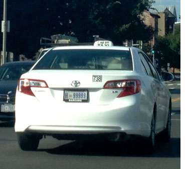 Hire plate no. H-99999 in use on a Toyota Camry