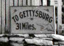 Close image of road sign identifying the road and distance to Gettysburg, Pa.